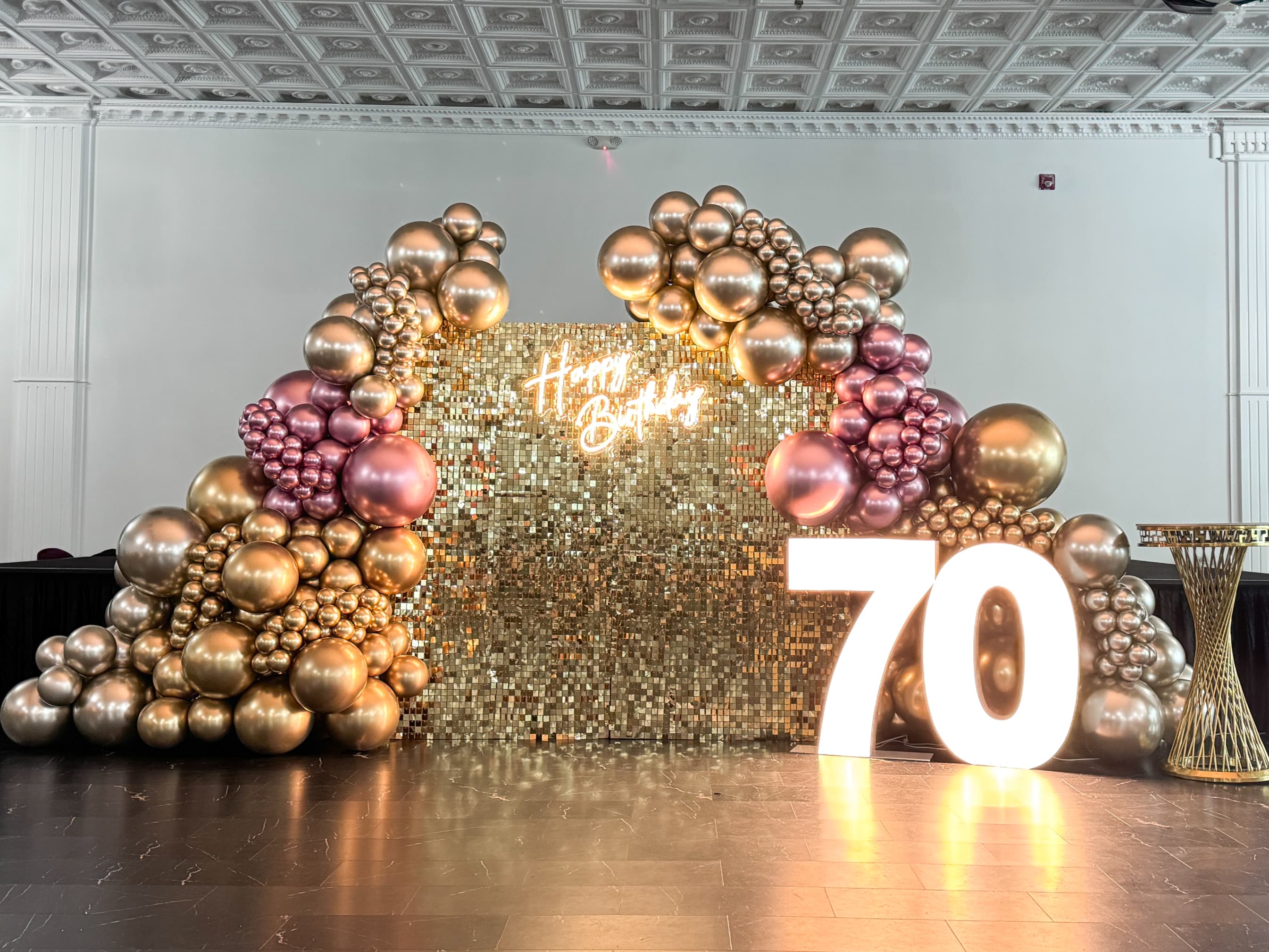 Warm-toned celebration setup with balloons and florals by Big Little Creations, Metro Vancouver